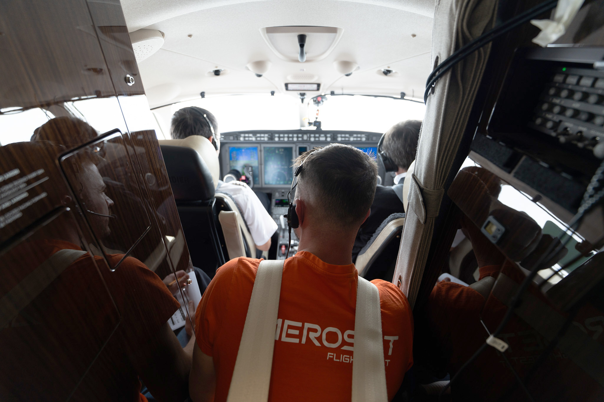 AEROSET flight test team working together onboard an aircraft during a flight test mission